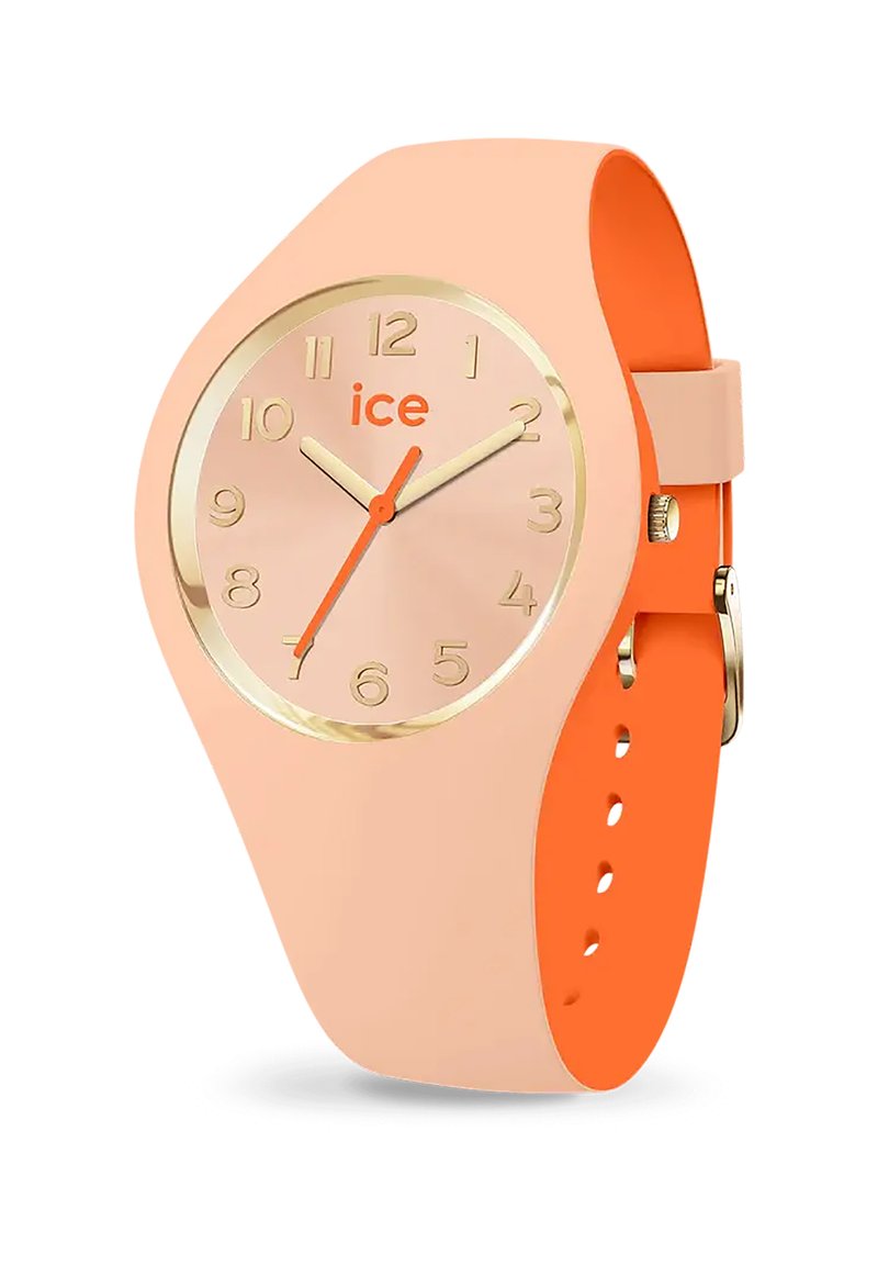 Orologio in silicone pesca con accenti dorati. Cassa rotonda che mostra i numeri da 1 a 12; lancetta delle ore arancione e cinturino. Texture liscia con un design moderno.