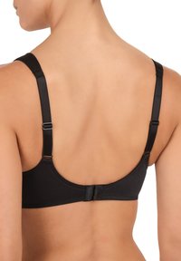 Soutien-gorge nero in un materiale liscio e elastico, con spalline regolabili e chiusura a gancio sul retro. Design e forma semplici.