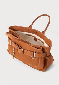 Brown leather tote bag with a textured surface, a wide opening, and a belt accent. Includes a zipper pocket and a small padlock detail.
