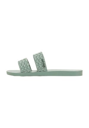 Sandali piatti di colore verde chiaro con due cinturini intrecciati, suola piatta e motivo texture. Realizzati in materiale flessibile, progettati per l'abbigliamento casual.