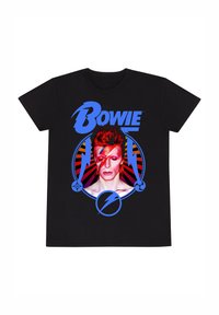 T-shirt nera con un design grafico di una persona con capelli rossi e trucco sul viso. Il testo "Bowie" è in blu, con accenti circolari.