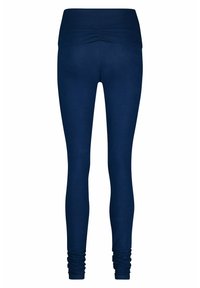 Marineblaue Leggings mit einer engen Passform, breitem, gerafftem Bund und gerüschten Knöcheldetails, hergestellt aus einem dehnbaren, glatten Material.