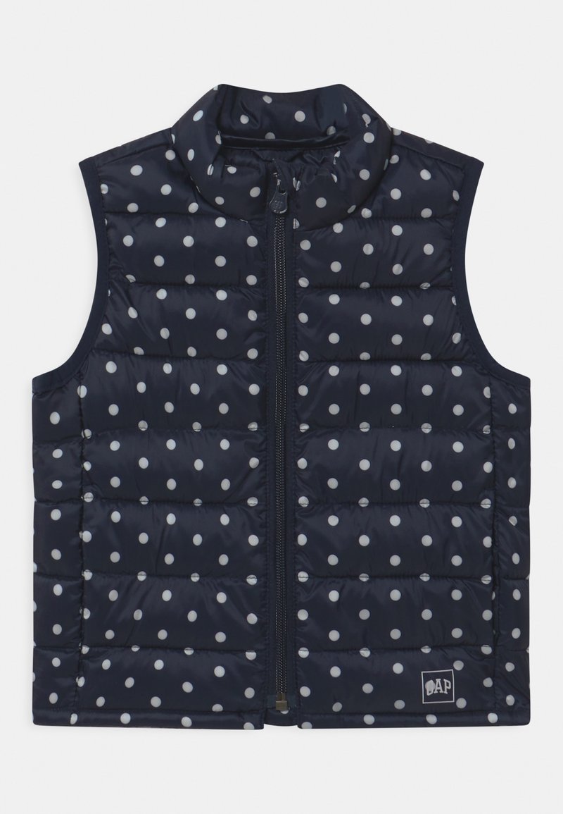 Námořnická prošívaná vesta s bílými puntíky, se zipem vpředu, vysokým límcem, polstrovaným designem a logem na dolním pravém rohu.