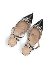 Pointed-toe flats with a black leather tip, snake-print design, adjustable ankle strap, and decorative bow accent with beads.