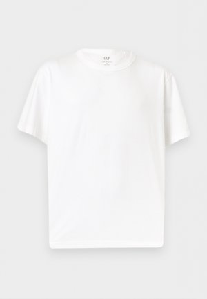 Vienkārša balta īsas piedurknes T-krekls ar apaļu kaklu, izgatavots no mīksta auduma, attēlots uz vienkārša gaiši pelēka fona.