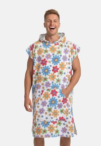 Huvponcho i mjukt tyg med vit bas och färgglada blommönster. Innehåller en framficka och sidospår.