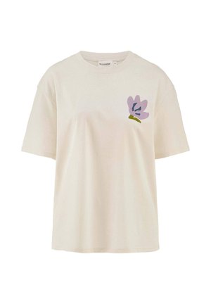 Cremfarbendes Baumwoll-T-Shirt mit lockerer Passform. Es hat ein pastelllila Blumenmuster auf der linken Brustseite. Mit kurzen Ärmeln.
