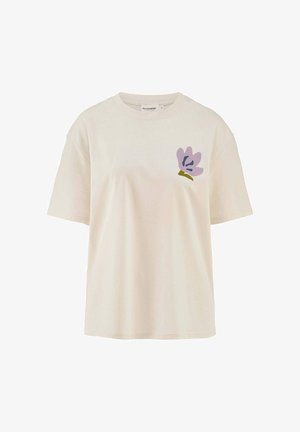 T-shirt di cotone color crema con un fit rilassato. Presenta un motivo floreale viola pastello nella zona sinistra del petto. Maniche corte.