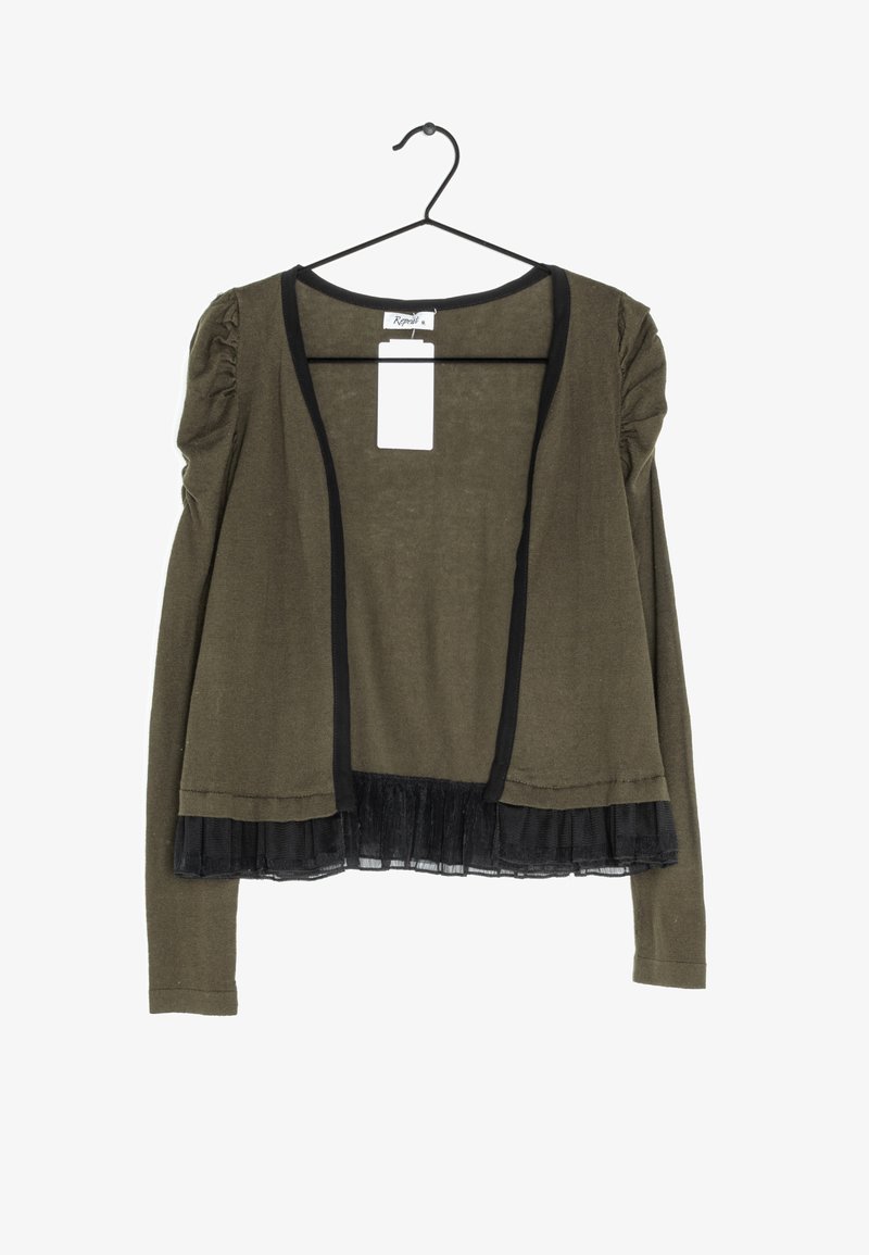 Olive green cardigan with black trim, featuring puffed sleeves and a black tulle frill at the hem. Hangs on a black hook.