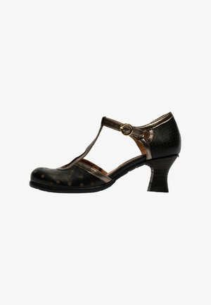 Chaussure à lanière en T en cuir noir avec des accents bronze, un talon incurvé de hauteur moyenne et une fermeture à boucle dorée, arborant des motifs à pois subtils.