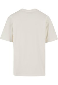 Cremefarvet kortærmet t-shirt lavet af blød bomuld, med en simpel rund halsudskæring og minimalistisk design uden synlige grafik.