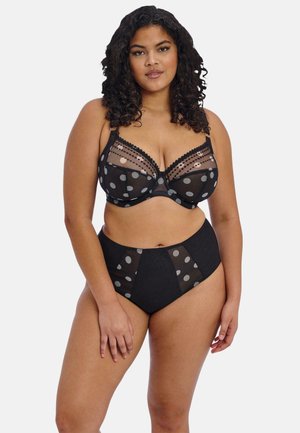 Zwarte lingerieset met polkadot gaas cups en hooggetailleerde slip met doorschijnende details. Geaccentueerd met kantafwerking voor extra textuur.