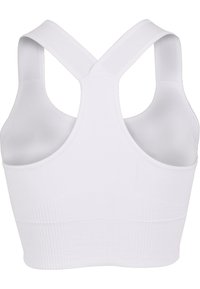 White sports bra with cross-back straps, ribbed texture at the hem, made from stretchy fabric for comfort and support.