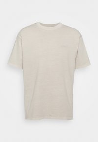Short-sleeve beige T-shirt made of soft cotton, featuring a subtle embossed logo on the chest and a crew neckline.