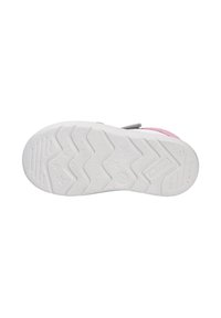 White sneaker outsole with textured zigzag pattern, featuring a robust grip and star accents. Upper part not visible.