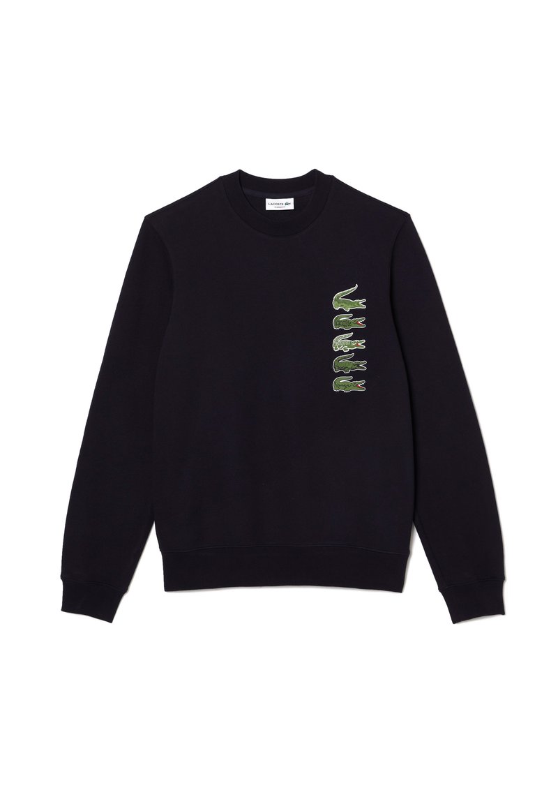 Sudadera de manga larga negra con cuello redondo, con cinco logotipos verdes de cocodrilo alineados verticalmente en el lado izquierdo del pecho.