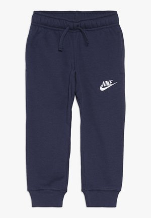 Pantalon de survêtement Nike bleu marine avec taille élastique et cordon, chevilles avec bord-côtes, et logo Nike blanc sur la cuisse gauche.