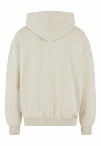 Beige hoodie with a drawstring hood, ribbed cuffs and hem, and a smooth, textured fabric. Simple design with no visible graphics or logos.