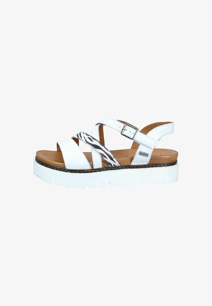 White platform sandal with brown footbed, adjustable ankle strap, and black-and-white zebra strap detail across the front.