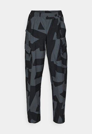 Cargo pants in a black and grey geometric pattern, featuring an elastic waistband, multiple pockets, and a relaxed fit.