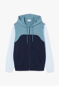 Sweat à capuche zippé avec un design en bloc de couleurs en bleu sarcelle, bleu marine et bleu clair. Comprend une poche kangourou et un petit logo.