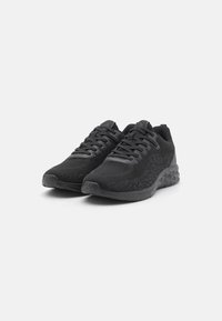 Black athletic shoes with a textured fabric upper, lace-up design, and a cushioned sole featuring a distinctive geometric pattern.