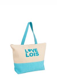 Bolsa de lona con un cuerpo crema y un fondo turquesa. Presenta un texto en azul bold "LOVE LOIS" con un acento de corazón. Tiras de transporte cómodas.