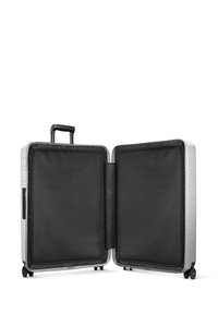 Silver hardshell suitcase with a telescopic handle, four wheels, and a black mesh interior. Two compartments with zipper closures.