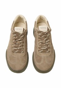 Beige suede sneakers with round toes, contrasting white stitching, and brown laces featuring a pattern. Thick rubber soles with a slight grip.