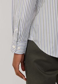 Langarm gestreept shirt in wit, marineblauw en olijf met knoopmanchetten, met smalle verticale strepen en een afgeronde zoom.
