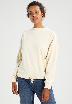Cremfarbener Sweatshirt mit lockerer Passform, Rundhals-Ausschnitt und Kordelzug am Saum. Weiches Material mit langen Ärmeln und gerippten Bündchen.