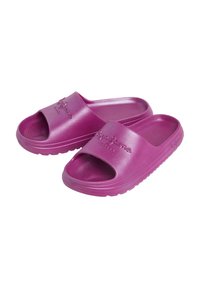 Lilla slip-on sandaler laget av skinnende plast. Designet har åpen tå, bred stropp med preget logo og teksturert fotseng.