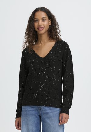 Black knitted sweater with a V-neck, featuring scattered white specks. Long sleeves and a relaxed fit, made from soft, textured fabric.
