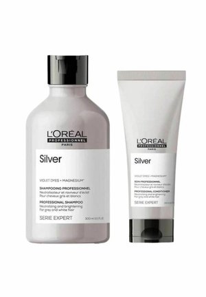 L’Oréal Professionnel Silver shampoo and conditioner bottles with black caps, labeled for neutralizing and brightening grey and white hair.