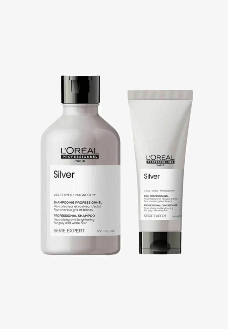 Shampoo- und Conditionerflaschen von L’Oréal Professionnel in Silber mit schwarzen Kappen, gekennzeichnet zur Neutralisierung und Auffrischung von grauem und weißem Haar.