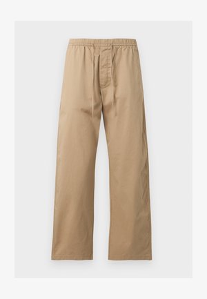 Hellbraune locker sitzende Hose mit elastischem Bund und vorne mit Kordelzug, aus leichtem Stoff, vor einem einfarbigen Hintergrund gezeigt.