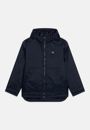 Navy blue hooded jacket with front zipper, two angled pockets, and small round logo patch on left chest.