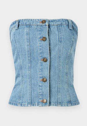 Denim tube topp i lyseblå med en tettsittende design. Har fem brune knappeåpninger og vertikale sømmer for formgiving.