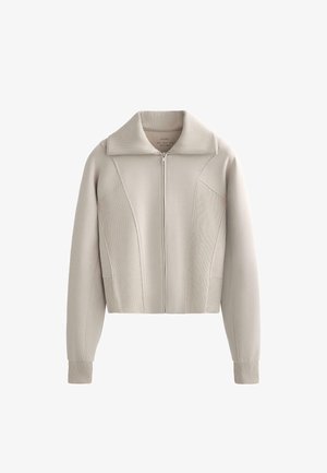 Gestreepte zip-up sweatvest in lichtbeige, met een geribbelde kraag en zijpanelen met textuurdetails. Zachte stof met lange mouwen.