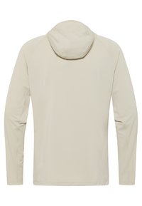 Chemise à manches longues beige avec capuche. Texture lisse, épaules sans coutures et ourlet inférieur arrondi. Design minimaliste sans logos ni motifs visibles.