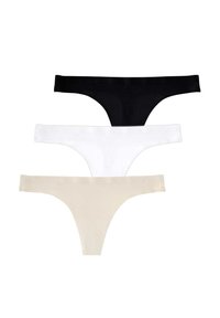 Trois strings en noir, blanc et couleur chair. Chacun présente un design sans couture, un tissu doux et une taille minimaliste.