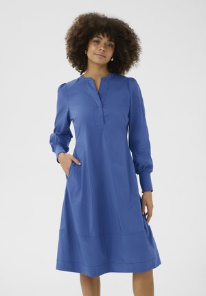 Blue, mid-length dress with a placket neckline, long puff sleeves, and side pockets. Made of smooth fabric with a slight sheen.