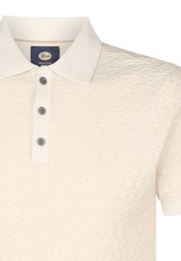 Crème-kleurige polo met een gestructureerd patroon, drie knopen en een geribde kraag. De stof lijkt zacht en ademend te zijn.