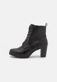 Bottes de cheville en cuir noir avec un talon épais, présentant un design à lacets, une surface texturée et une languette au dos pour un enfilage facile.