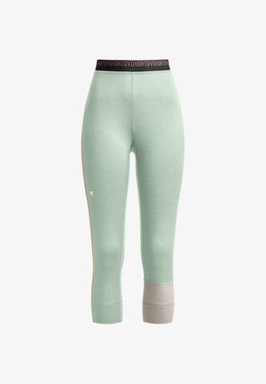 Hellgrüne Sportleggings mit einem schwarzen Bund, die kontrastierende beige Akzente an den unteren Beinen aufweisen und eine glatte, dehnbare Textur besitzen.