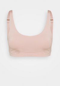 Heller rosa nahtloser BH mit breiten Trägern, großzügigem Ausschnitt und verstellbaren Hardwaredetails. Hergestellt aus weichem, dehnbarem Material.