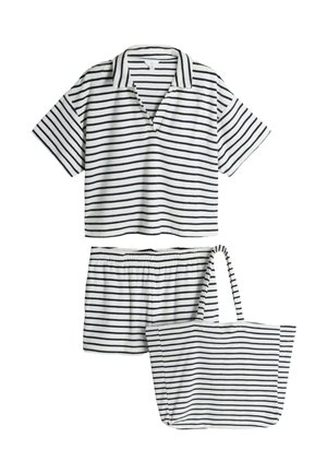 Polo à manches courtes blanc et noir à rayures horizontales, short assorti avec taille élastique, et sac fourre-tout rayé.