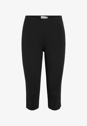 Legging noir ajusté longueur genou avec une taille haute, en tissu stretch, avec une petite fente latérale à l'ourlet.