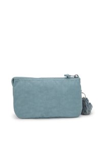 Light blue pouch made of textured fabric, featuring a zipper closure and a fluffy pom-pom attached to the side. Compact and rectangular shape.