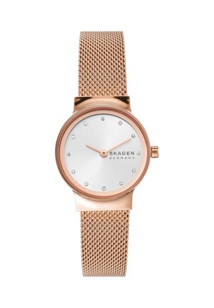 Montre-bracelet Skagen en or rose avec bracelet en maille, cadran blanc minimaliste, index heures en cristal, sans chiffres sur le cadran.